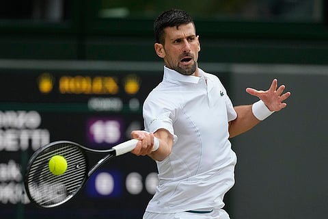 Novak Djokovic plays a forehand return to Lorenzo Musetti